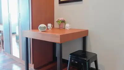 a table with two mugs and a vase of flowers on it at Today Tonight in Bangkok
