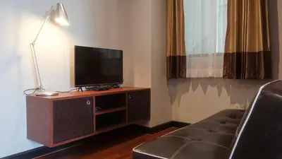 a living room with a tv and a couch at Today Tonight in Bangkok