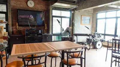 a room with a table and chairs and a television at Today Tonight in Bangkok
