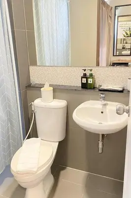 a bathroom with a toilet and a sink at Casa Luxe Hotel and Resident in Bangkok