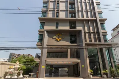 a building with a sign on the front of it at Casa Luxe Hotel and Resident in Bangkok