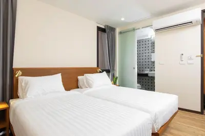 a bedroom with a large bed with white sheets at Sukhon Hotel - SHA Plus in Bangkok