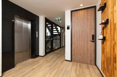 an office corridor with a door and a hallway with glass at Sukhon Hotel - SHA Plus in Bangkok