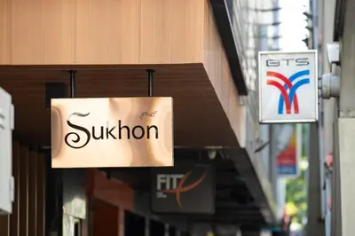 a sign for a sunion store hanging from a building at Sukhon Hotel - SHA Plus in Bangkok