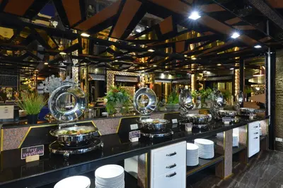 a buffet line with plates and bowls of food at The Breton Hotel Media in Bangkok