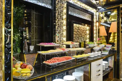 a buffet with many plates of food on display at The Breton Hotel Media in Bangkok