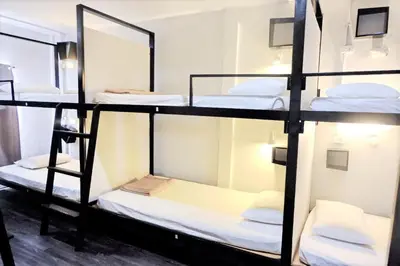 a group of bunk beds in a room at Bangkok Nomad Hostel in Bangkok