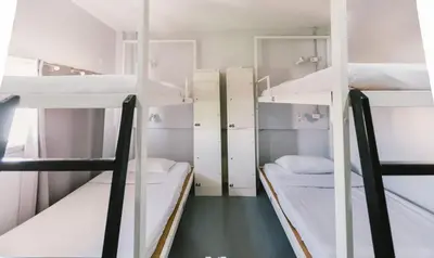 a dorm room with three bunk beds in it at Bangkok Nomad Hostel in Bangkok