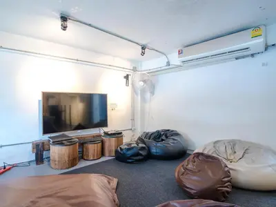 a room with two bean bags and a flat screen tv at Bangkok Nomad Hostel in Bangkok