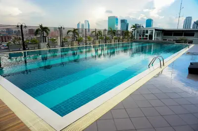 a large swimming pool on top of a building at Witchuwan Apartel in Bangkok