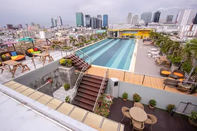 a swimming pool on the roof of a building at Witchuwan Apartel in Bangkok