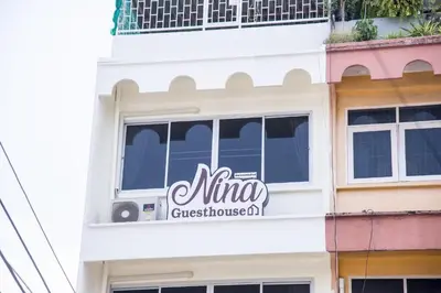 a building with a muna guesthouse sign on it at ninaguesthouse in Bangkok