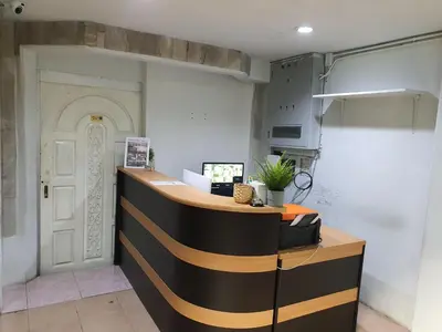 a kitchen with a counter and a white door at NK Guesthouse 2 in Bangkok