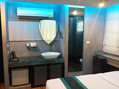 a bathroom with a sink and a mirror at Blutique Hotel in Bangkok