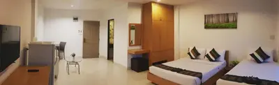 a hotel room with two beds and a kitchen at Sena House in Bangkok