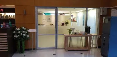 a room with glass doors and a vase of flowers at Sena House in Bangkok