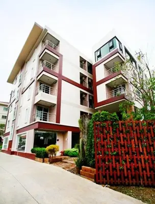 a building with a red fence in front of it at The Loft Resort Bangkok in Bangkok