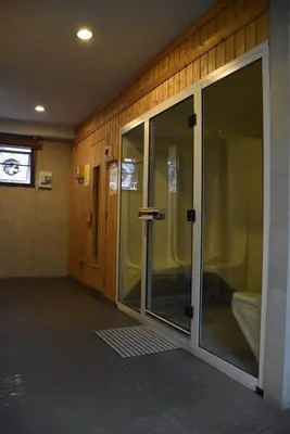 an empty room with glass doors in a building at De Junction House in Bangkok