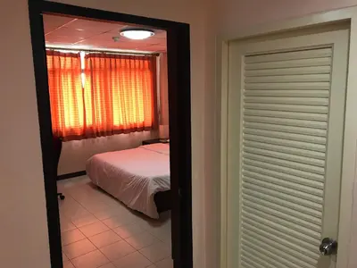 a view of a bedroom with a bed and a mirror at De Junction House in Bangkok