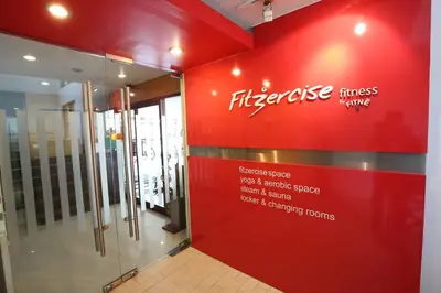 a store with a red wall with a sign on it at De Junction House in Bangkok