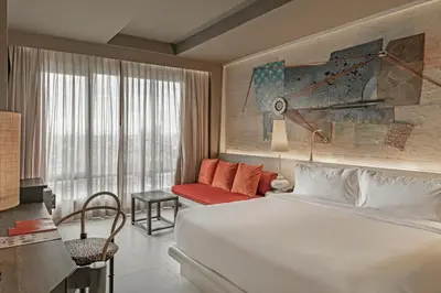 a hotel room with a bed and a couch at Siam At Siam Design Hotel Bangkok in Bangkok