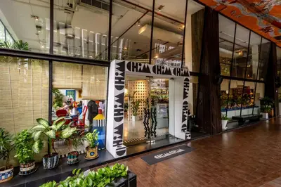 a store front with plants and a sign in a building at Siam At Siam Design Hotel Bangkok in Bangkok