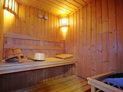 a wooden sauna with a shelf and a lamp at Centre Point Plus Hotel Silom - Newly Renovated in Bangkok