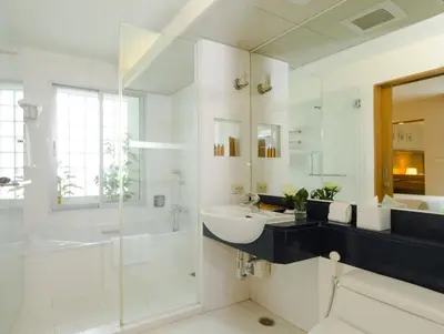 a bathroom with a sink and a tub and a shower at AT EASE saladaeng by AETAS in Bangkok