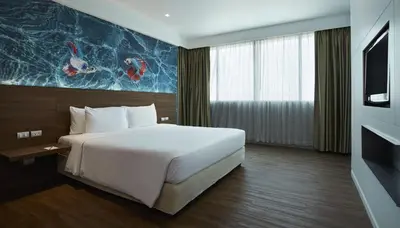 a hotel room with a bed and a tv at Centara Life Government Complex Hotel & Convention Centre Chaeng Watthana in Bangkok