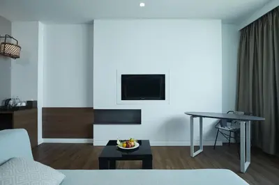 a living room with a couch and a table at Centara Life Government Complex Hotel & Convention Centre Chaeng Watthana in Bangkok