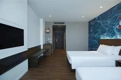 a hotel room with a bed and a flat screen tv at Centara Life Government Complex Hotel & Convention Centre Chaeng Watthana in Bangkok