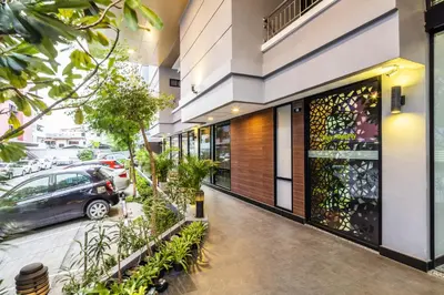a building with a car parked outside of it at Aliz Hotel in Nonthaburi