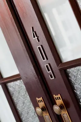 a wooden door with the word ak on it at Baan Chart in Bangkok