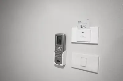 a cell phone is hanging on a wall at So good Hotel Bangkok in Bangkok