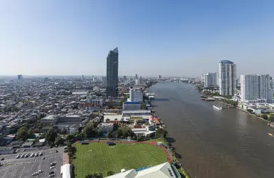 an aerial view of a city with a river and buildings at Chatrium Hotel Riverside Bangkok in Bangkok