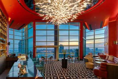a large lobby with a chandelier in a building at Chatrium Hotel Riverside Bangkok in Bangkok