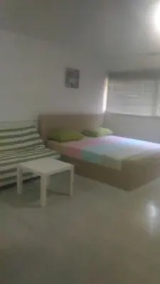 a bedroom with two beds and a table in it at T8 IMPACT BANGKOK Thailand in Bangkok
