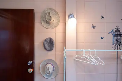 a bathroom with hats hanging on a wall at Dunah's Garden Home in Bangkok