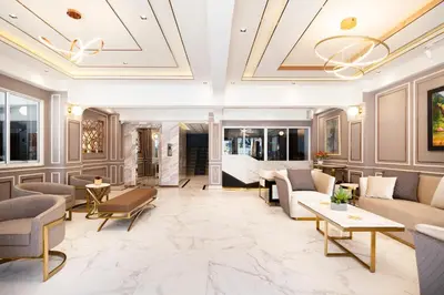 a living room with furniture and a coffered ceiling at Penyos Suite in Bangkok