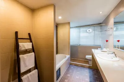 a bathroom with a sink and a tub and a toilet at The Best Bangkok House in Bangkok