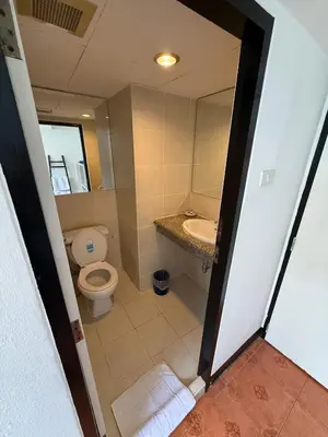an open door to a bathroom with a toilet and sink at The Best Bangkok House in Bangkok