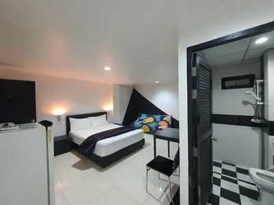 a bedroom with a bed and a bathroom at @Room Apartment in Bangkok