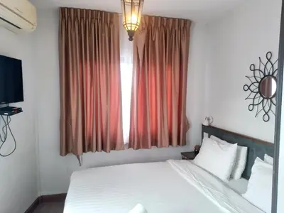 a bedroom with a bed and a large window at Chetuphon Gate in Bangkok
