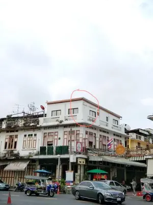 a large white building with cars parked in front of it at Chetuphon Gate in Bangkok