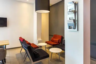 a waiting room with chairs and a table at Easy Planet Bangkok Asoke in Bangkok