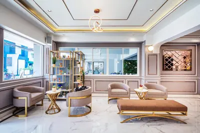 a lobby with chairs and tables and a window at Penyos Mansion (Long Stay) in Bangkok