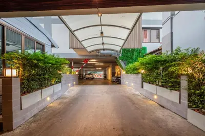 an empty hallway in a building with plants at Penyos Mansion (Long Stay) in Bangkok
