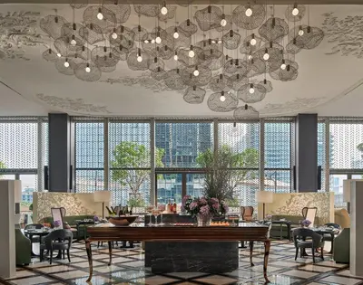 a large dining room with a large chandelier at Rosewood Bangkok in Bangkok