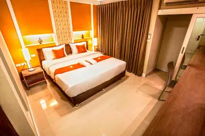 a bedroom with a large bed in a room at The Aim Sathorn Hotel in Bangkok