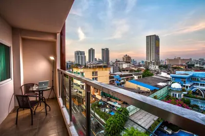 a balcony with a view of a city at The Aim Sathorn Hotel in Bangkok